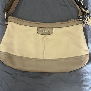 Tan coach shoulder bag.